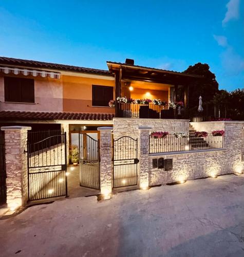 a house with a gate with lights on it at Affittacamere Residenza Montedoro in Norcia