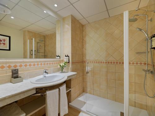 a bathroom with a sink and a shower at H10 Salou Princess in Salou