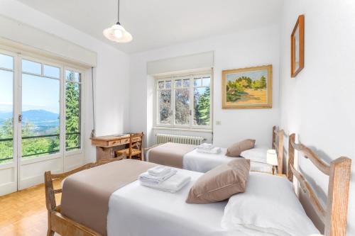 Ένα ή περισσότερα κρεβάτια σε δωμάτιο στο Villa Nelma by Casa da Suite
