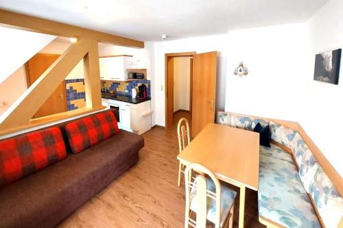a living room with a couch and a table at Pension Appartements Gabriele in Bad Gastein