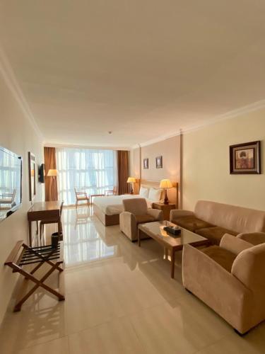 a large living room with couches and a table at City Center Hotel in Mawāliḩ