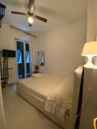 a bedroom with a bed and a ceiling fan at Hotel Leopold in Moneglia
