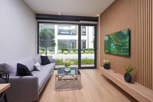 a living room with a couch and a table at Apartamenty Olimpijska by RENT4YOU in Olsztyn
