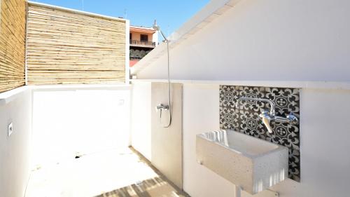 a bathroom with a sink on the side of a building at Les Maisons Casetta del Vico by Rentbeat in Sannicola