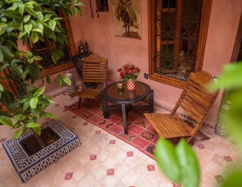 an overhead view of a patio with two chairs and a table at Riad Zayane Atlas in Marrakech