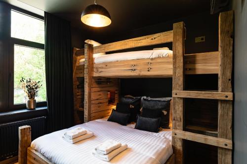 a bedroom with two bunk beds with towels on them at Le Moulin Noir à 400m du circuit in Francorchamps
