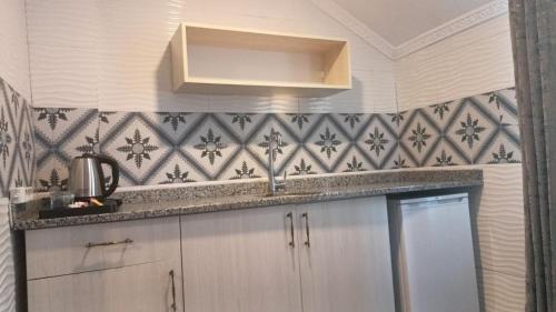 a kitchen with a sink and a counter top at Castle Light Boutique in Alanya
