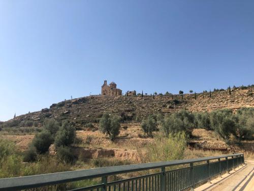 a castle on top of a hill with a bridge at Casa Rural El Corral del Tío Santiago in Mazaleón