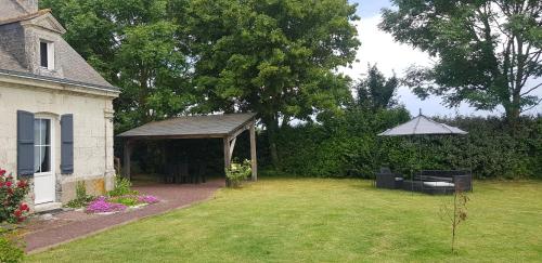 a backyard with a gazebo and a lawn at Lorali in Gohier