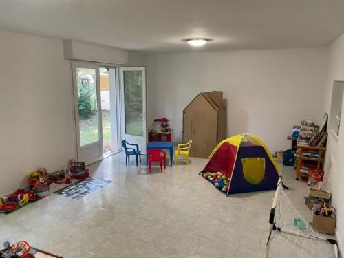 a living room with a tent and toys on the floor at Belle Villa basque avec piscine et jardin de 3000m2 in Saint-Jean-de-Luz