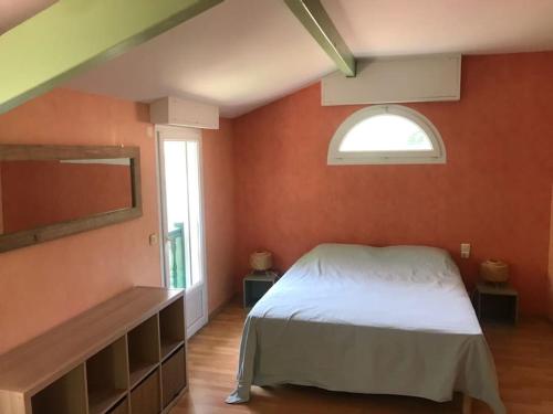 a bedroom with a white bed and a window at Belle Villa basque avec piscine et jardin de 3000m2 in Saint-Jean-de-Luz