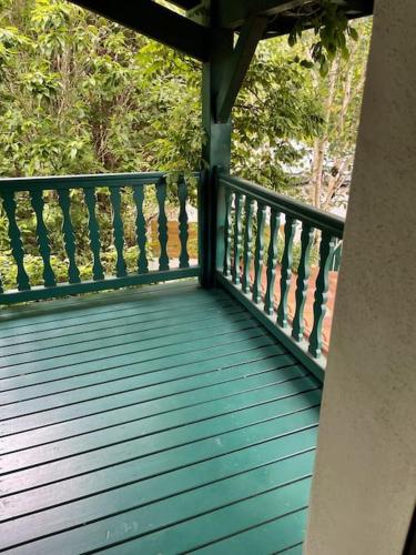a wooden deck with a railing on a porch at Belle Villa basque avec piscine et jardin de 3000m2 in Saint-Jean-de-Luz