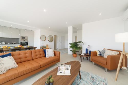 a living room with a couch and a table at Nazaré Views X - By SCH in Nazaré