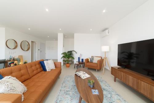 a living room with a couch and a flat screen tv at Nazaré Views X - By SCH in Nazaré