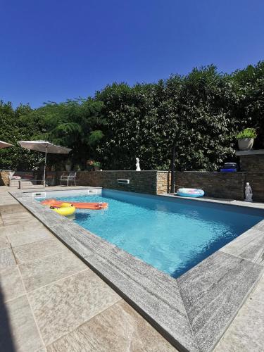 a large swimming pool with an inflatable at Indè Noi - Maison de village proche commodités in Murato
