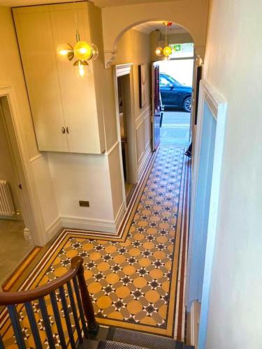a hallway with a staircase with a tile floor at The Glen House in Kinsale