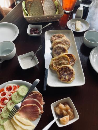 a table topped with plates of food with bread at Stara Szkoła in Krempna