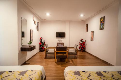 a room with a table and chairs and christmas decorations at Tripli Hotels Arunoday Palace in Udaipur