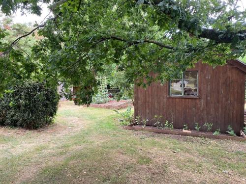 a small building with a window in a yard at Cabin Sleeps 4 with Garden & Free Parking in Ross on Wye