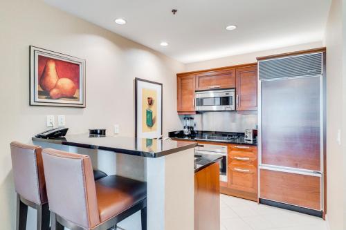 a kitchen with wooden cabinets and a counter top at Jet Luxury Elite at The Signature in Las Vegas