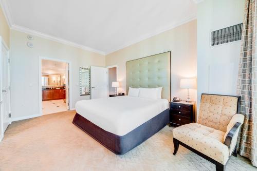 a large bedroom with a large bed and a chair at Jet Luxury Elite at The Signature in Las Vegas
