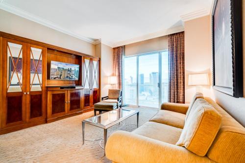 a living room with a couch and a tv at Jet Luxury Elite at The Signature in Las Vegas