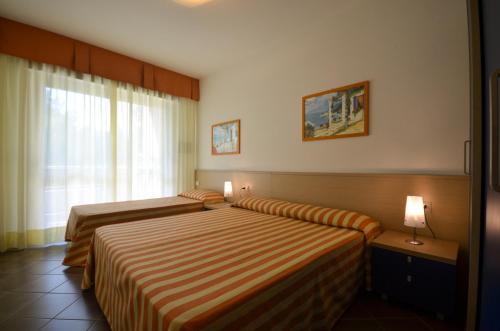 Ένα ή περισσότερα κρεβάτια σε δωμάτιο στο Residenza Al Parco