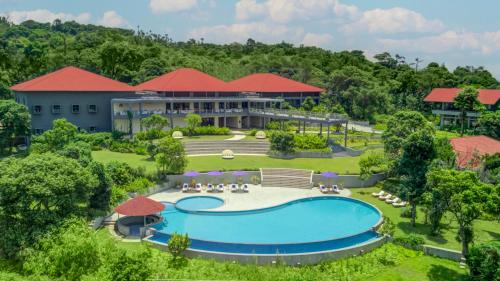 an aerial view of the resort with a swimming pool at Aurika, Coorg - Luxury by Lemon Tree Hotels in Madikeri