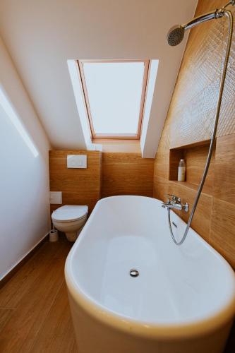 a bathroom with a white toilet and a sink at Hotel Restaurant Park in Miercurea-Ciuc