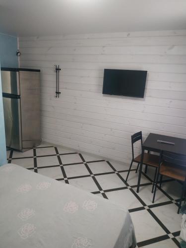 a room with a bed and a table and a tv at Svitiaz Griada in Szack