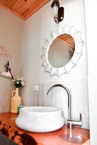a bathroom with a sink and a mirror at Smyrna Pansiyon in Kaş