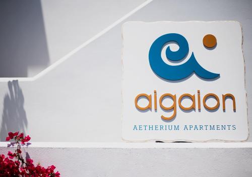 a sign for anzaiumagents on a wall at Aigaion Aetherium Apartments in Livadakia