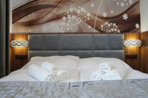 a bed with white towels on top of it at Hotel Biele Studničky Dargov in Dargov