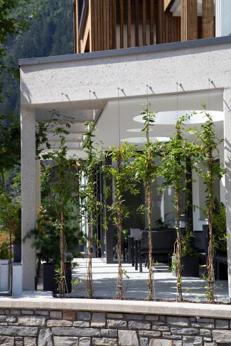 a group of trees in front of a building at Hotel & Suites Glück Auf in Mayrhofen