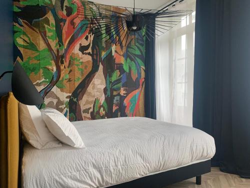 - une chambre avec un lit orné d'une peinture murale dans l'établissement Pau's Appart - Pau Centre, à Pau