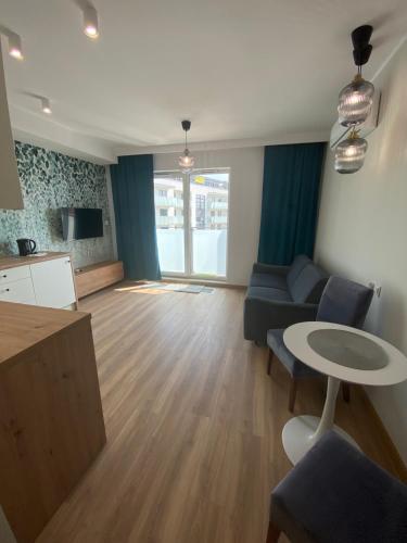 a living room with a couch and a table at Apartamenty Białe nad jeziorem Białym in Augustów