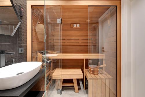 a bathroom with a shower and a sink at Downtown Apartments Granaria Premium Riverside & Parking in Gdańsk