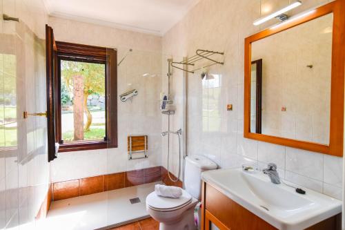 a bathroom with a sink and a toilet and a window at Encantadora casa con espectaculares vistas in Ajo