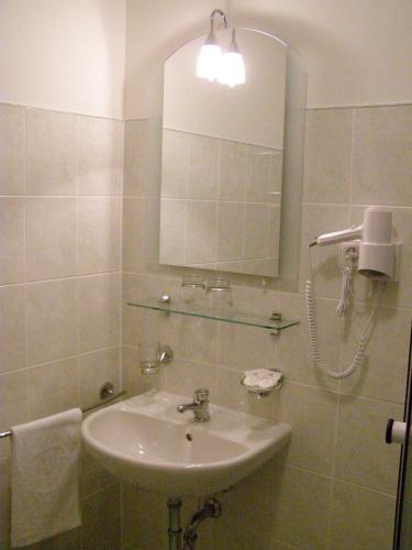 a bathroom with a sink and a mirror at Wellness Hotel Marlin in Nová Pec