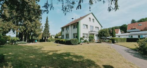 a large white house with a large yard at Steinhägerquelle in Steinhagen