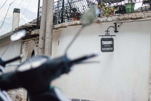 a blurry picture of a sign on the side of a building at Trigona Guest House & Hostel in Gjirokastër