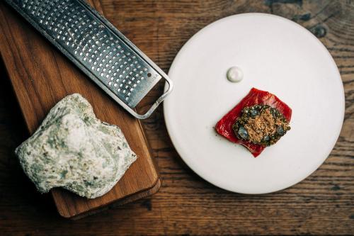 a white plate with a piece of food and a knife at La Mirande in Avignon