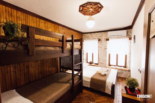 a room with two bunk beds and a couch at Trigona Guest House & Hostel in Gjirokastër