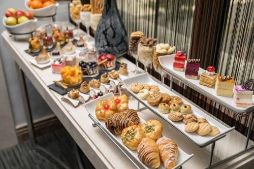 a buffet line with different types of pastries and desserts at Elaf Al Taqwa Hotel in Al Madinah