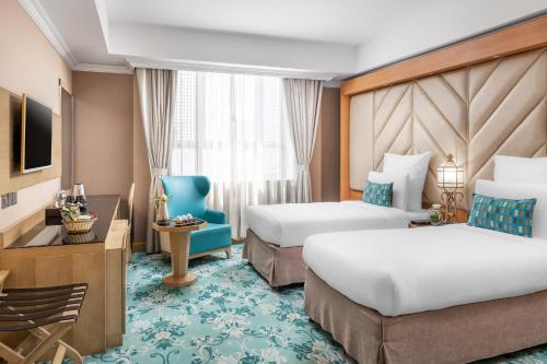 Tempat tidur dalam kamar di Elaf Al Taqwa Hotel