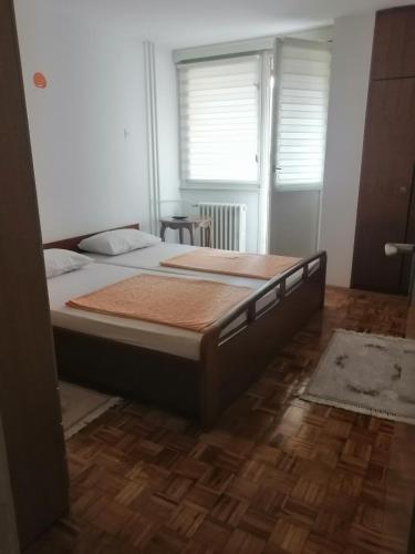 a bedroom with a large bed in a room at HomeB&E in Tuzla