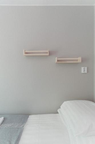 a bedroom with two shelves on the wall and a bed at Hotel Mathildedal in Mathildedal