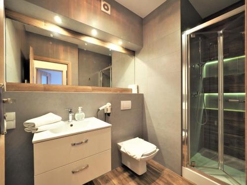a bathroom with a toilet and a sink and a shower at VIP Apartamenty Stara Polana 2 in Zakopane