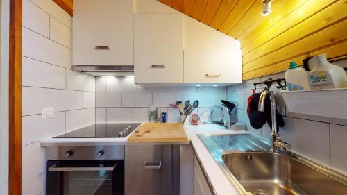 a kitchen with a sink and a counter top at Beautiful apartment for 4 people with a splendid view of les Dents du Midi in Champoussin