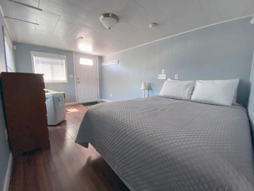 a bedroom with a large bed and a window at Island View Motel in Old Orchard Beach